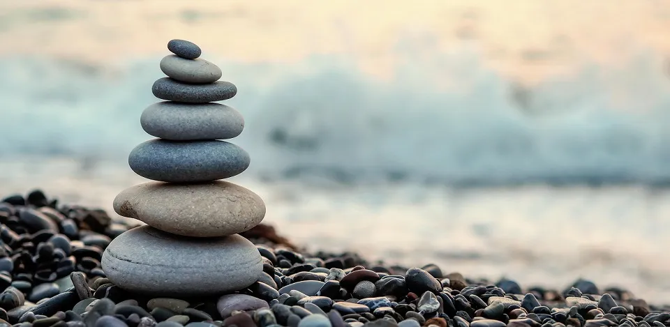 rocks stacked in front of the ocean